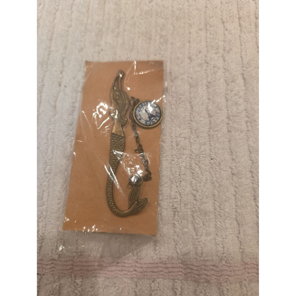 vintage-style metal mermaid bookmark featuring a charm dangle with text "PARIS".